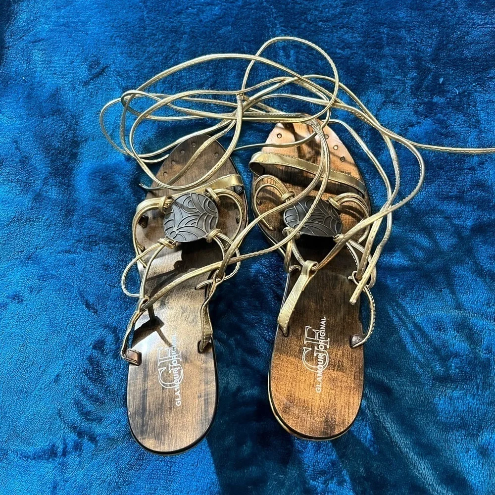 Sandals by Glamour Original! Lace up/wrap around the leg. Gold color!